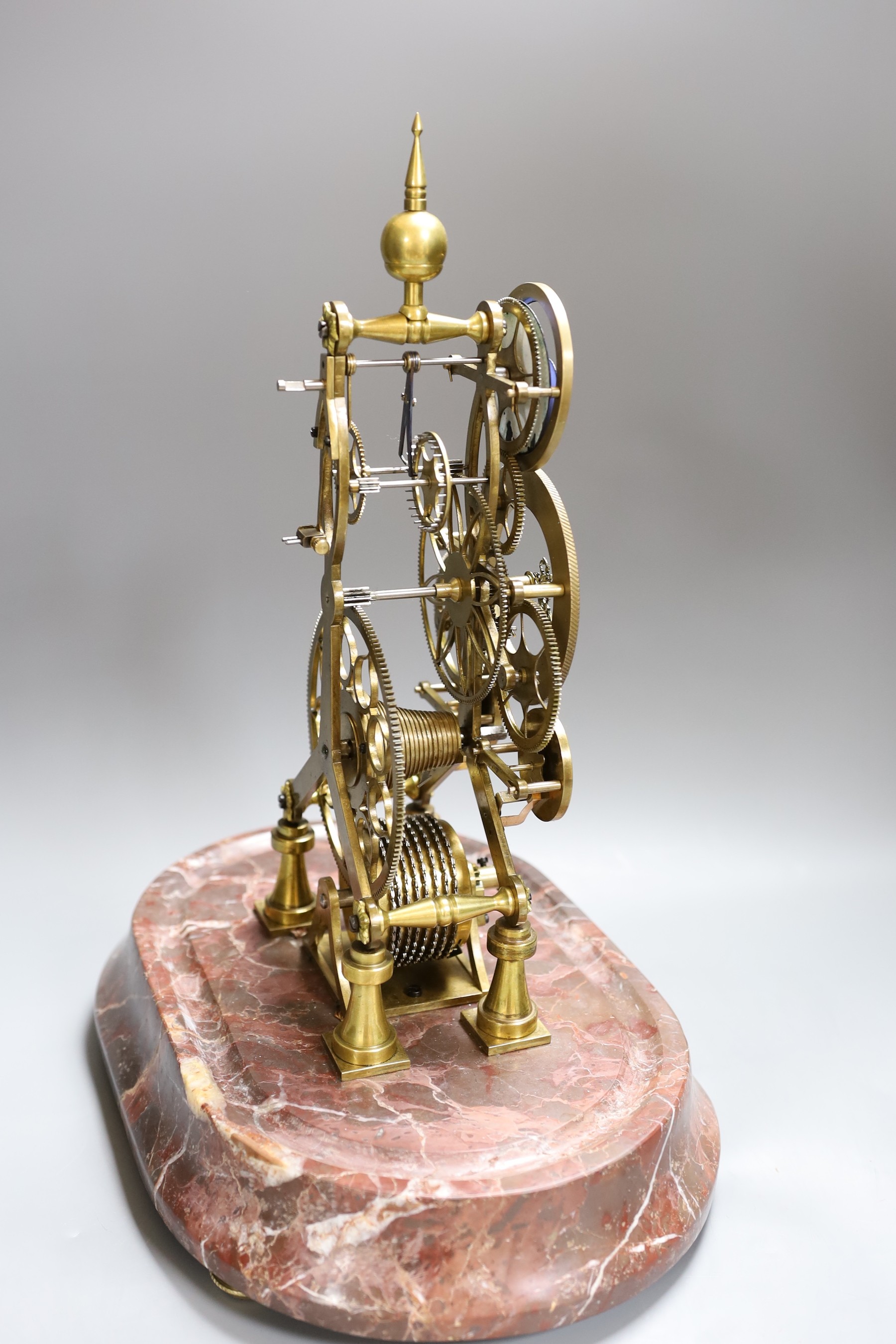 A calendar skeleton clock with moon phase dial, pin wheel escapement, dial signed Franz Denk in Wien, with pendulum, 50cm tall including dome